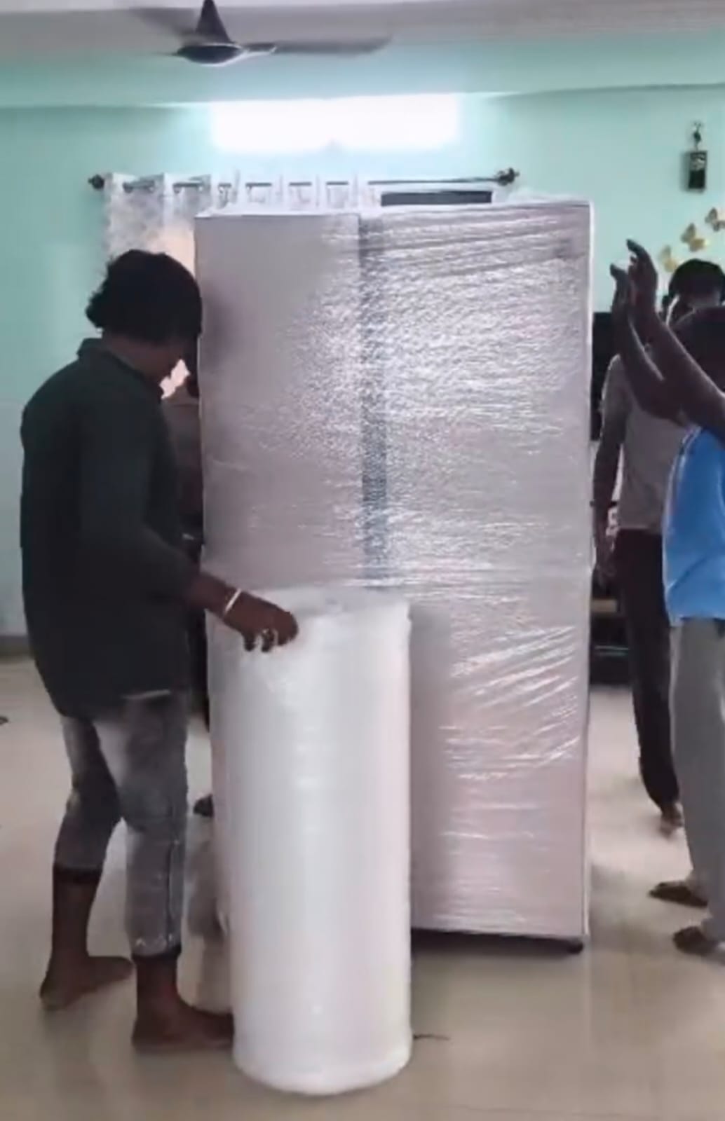 Refrigerator fully wrapped in bubble film and stretch wrap before loading